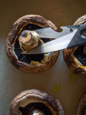 chopping off mushroom stalks with scissors