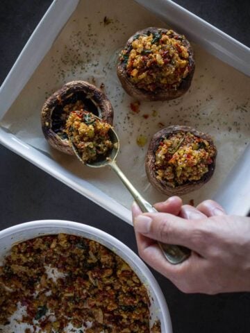 filling mushrooms caps with portobello stuffing.