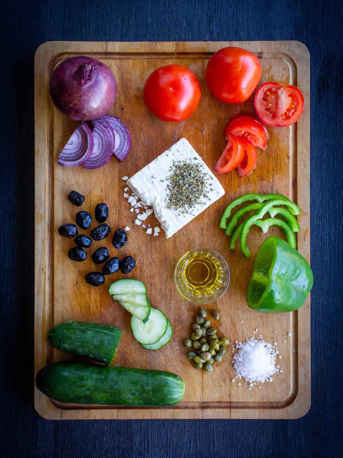vegan greek salad ingredients in a wooden table
