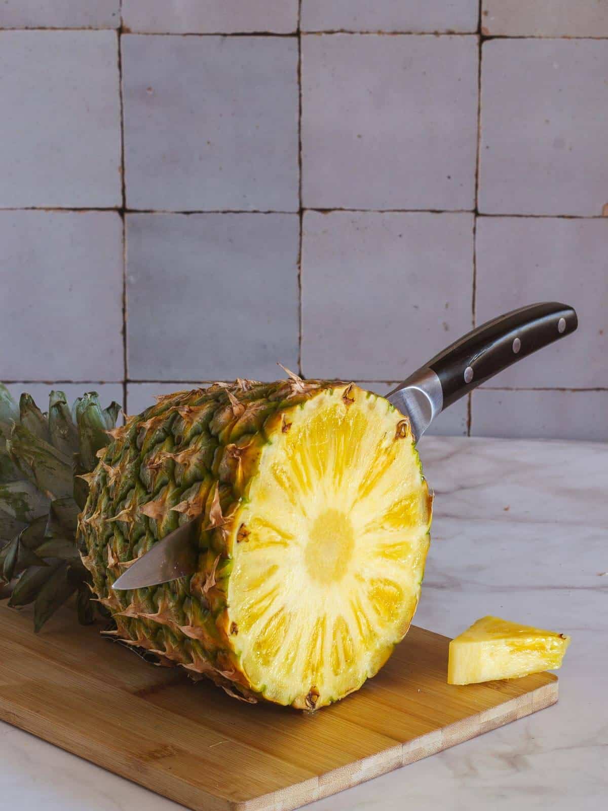 chopping fresh pineapple.