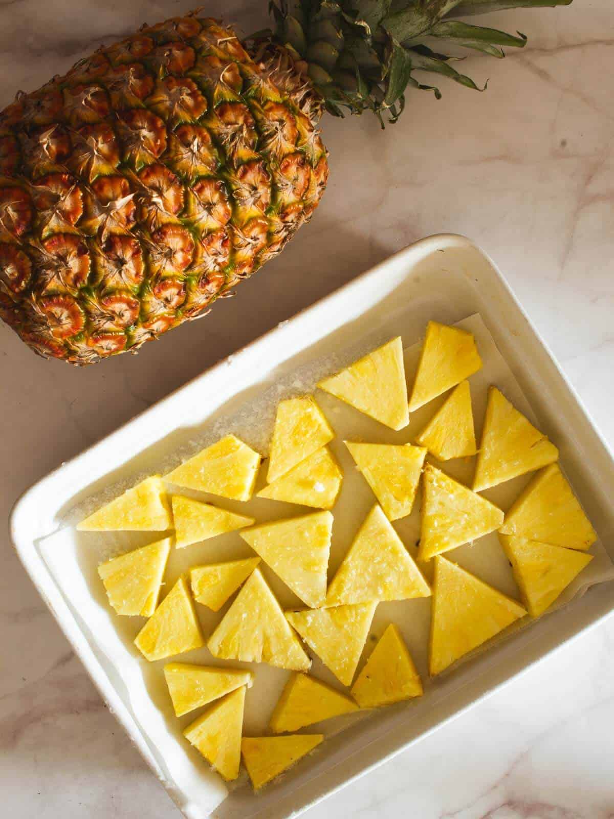 freeze pineapple chunks in a baking sheet with parchment paper