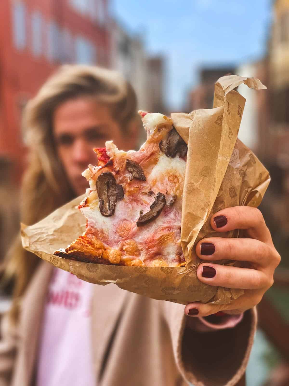 Woman with a Pizza slice in the hand