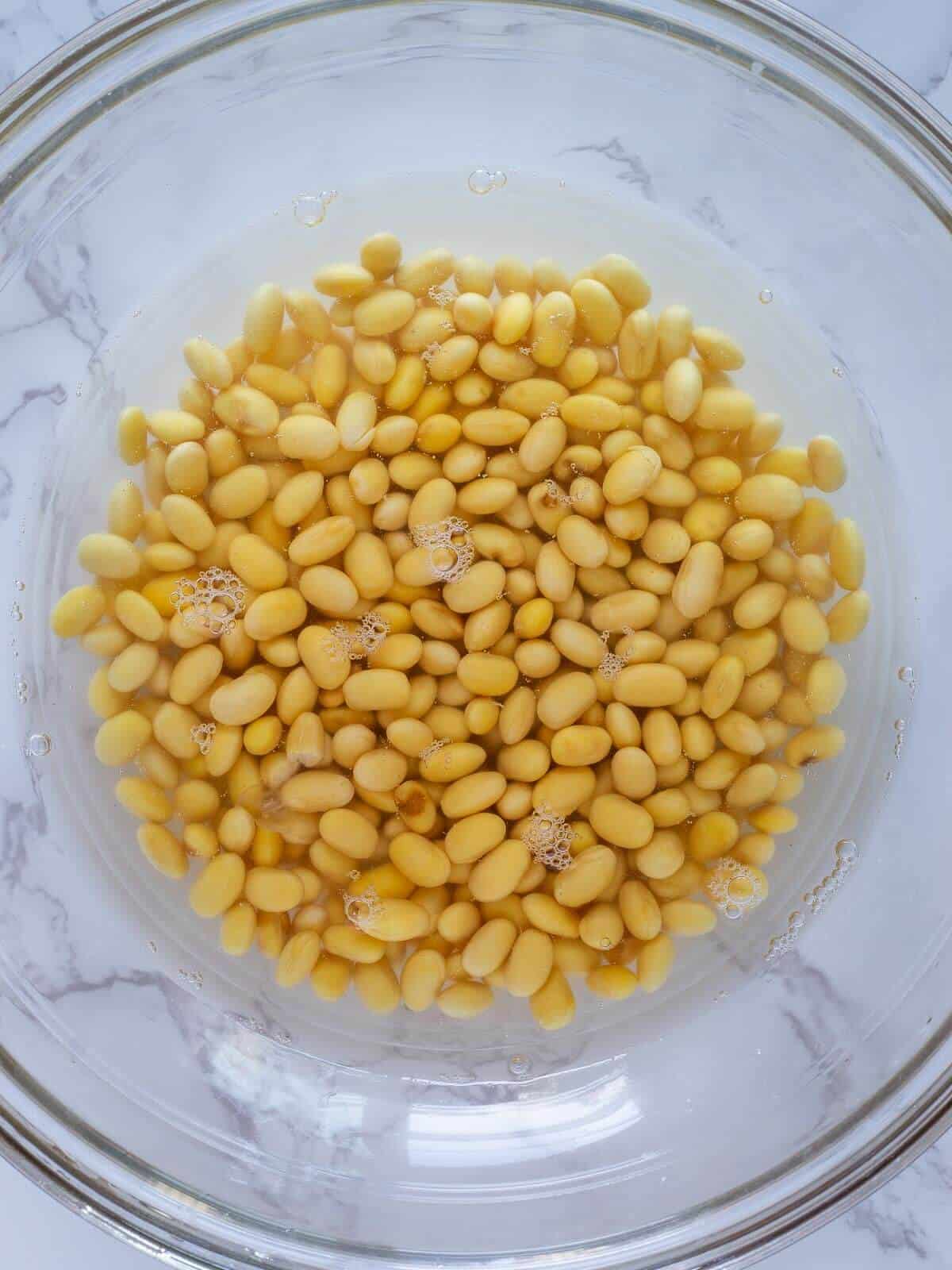 soaking soybeans in a bowl with water.