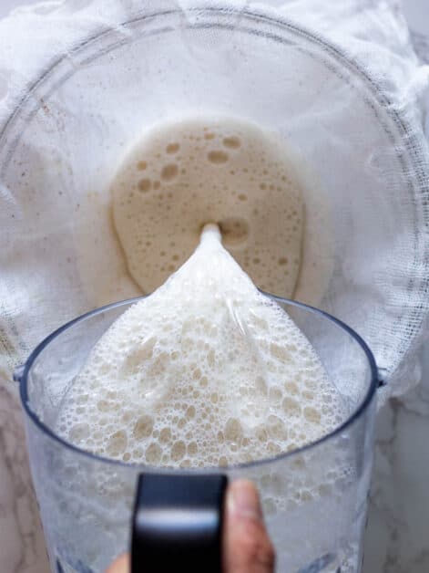 pouring soymilk into cheesecloth