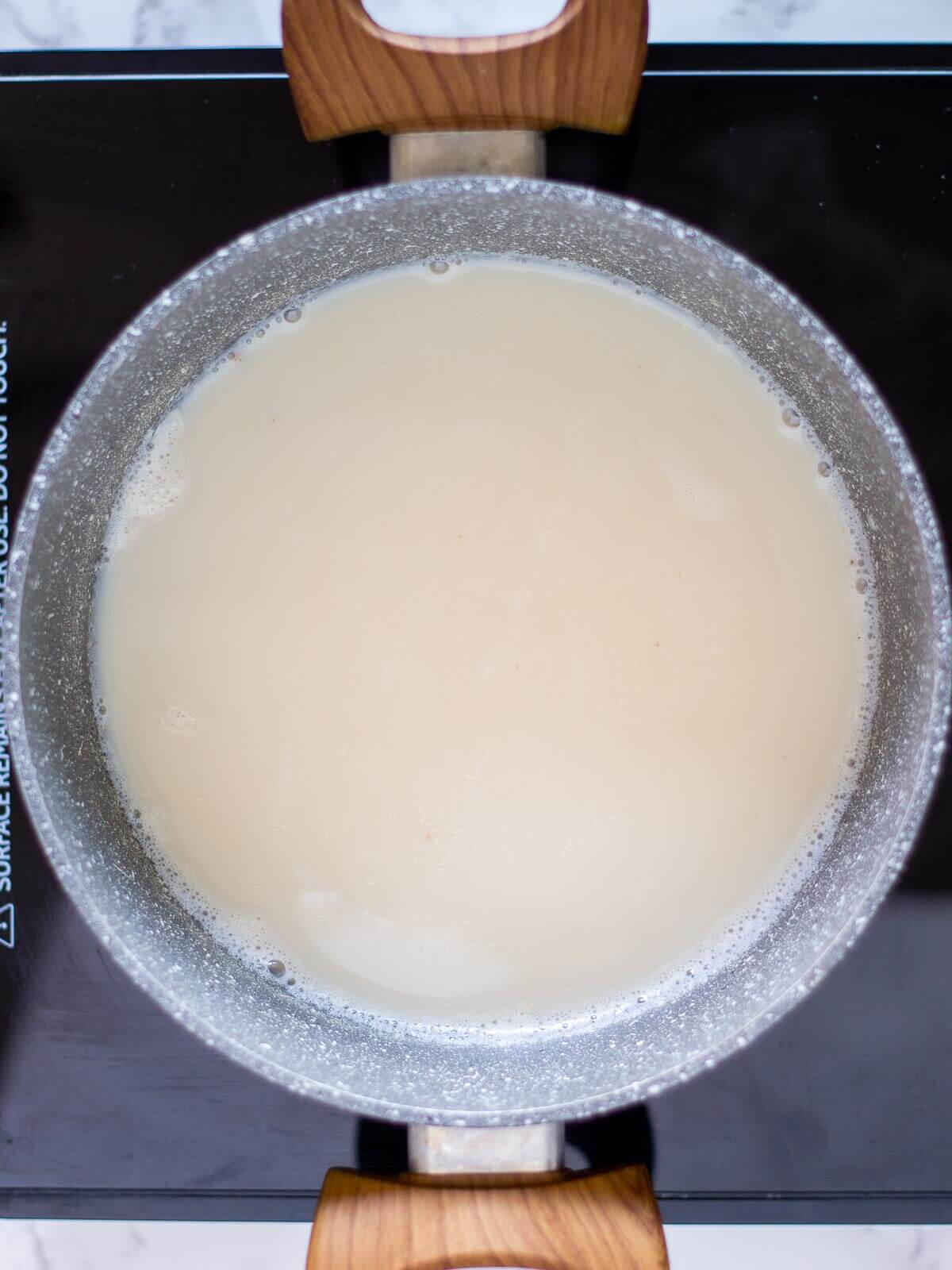 warming soy milk in saucepan.