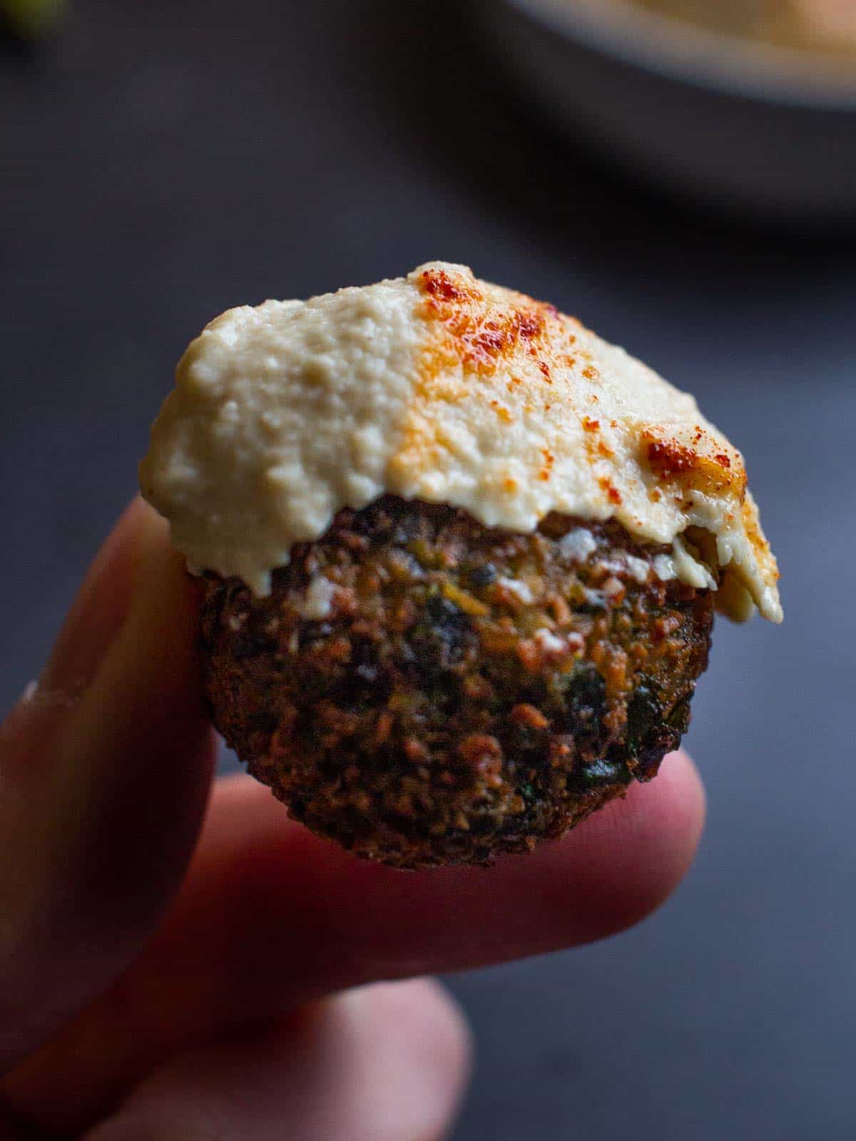 Falafel ball with Lebanese hummus served as finger food.