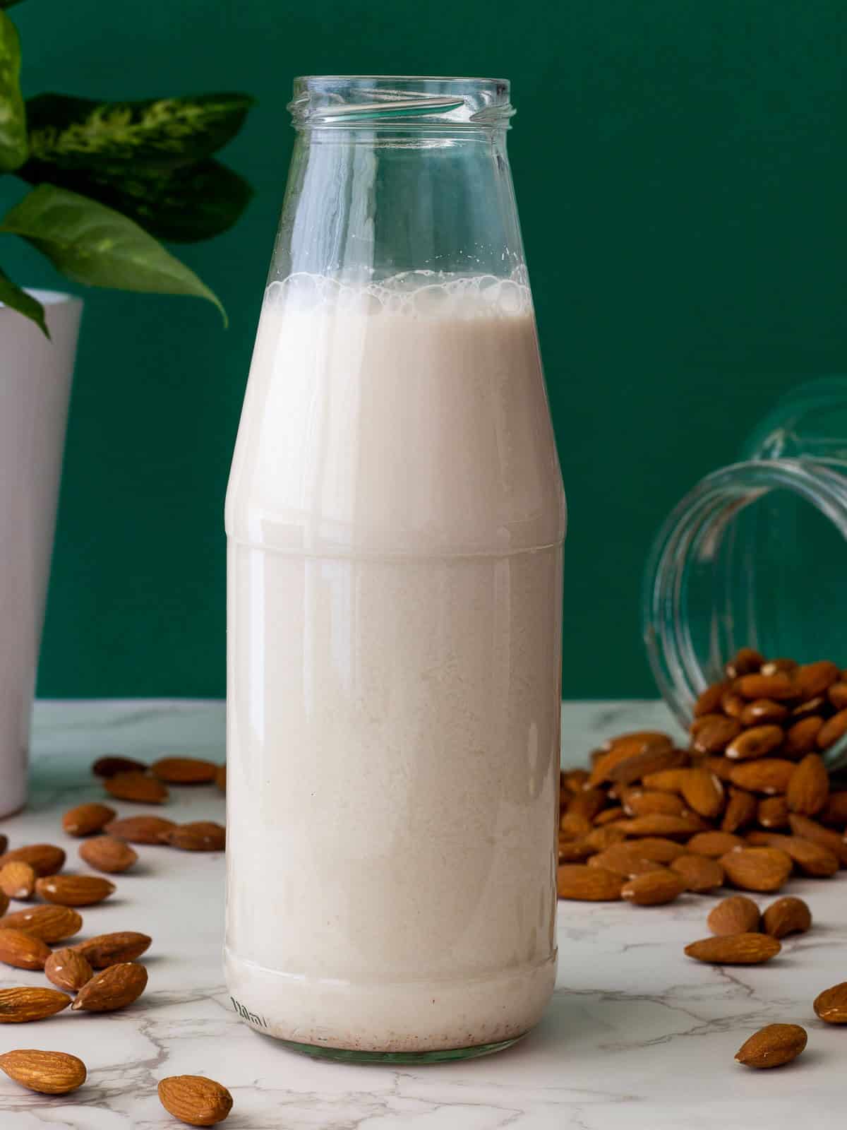 glass bottle with homemade almond milk.