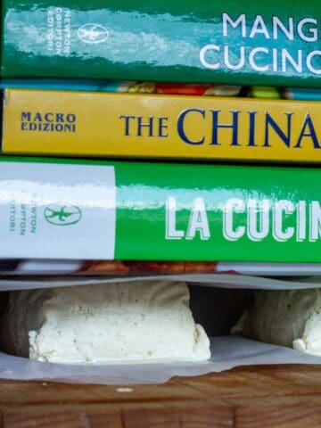 Pressing Tofu with books on top for extra weight