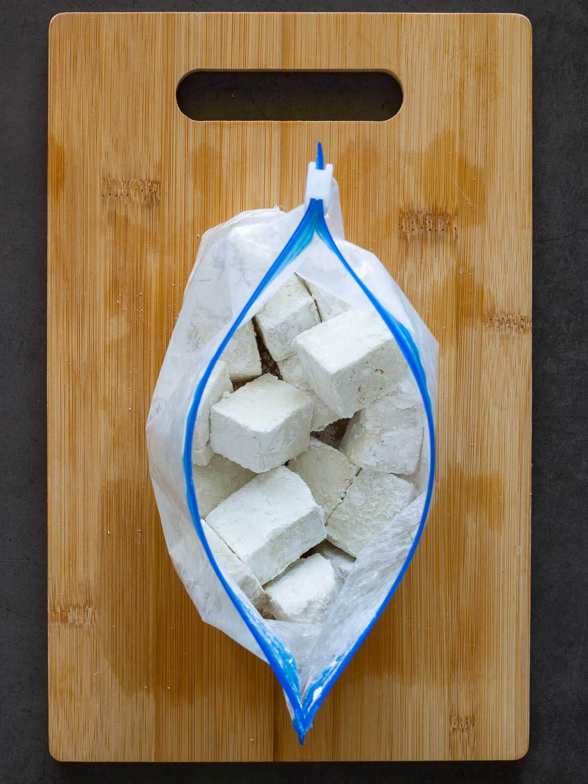 add the tofu dices along to Cornstarch to a Ziplock bag