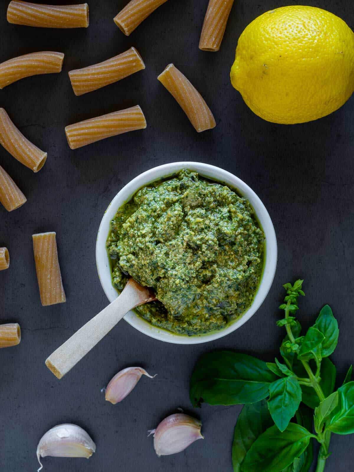 vegan lemon basil pesto in a small bowl with a spoon.