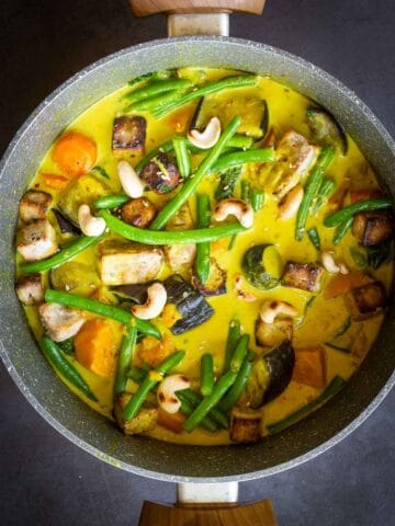 Vegetarian Yellow Curry Pot with green beans on top.