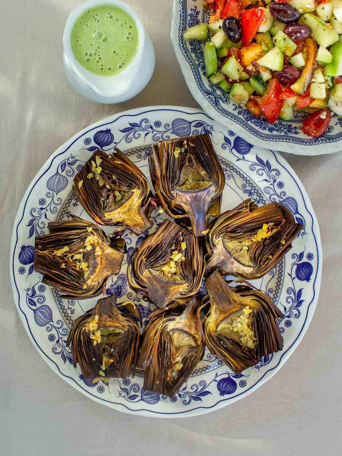 artichokes with dipping sauce for a vegan spring appetizer