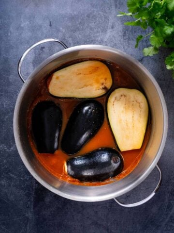 place the sliced eggplants on top of the tomato sauce mixture.