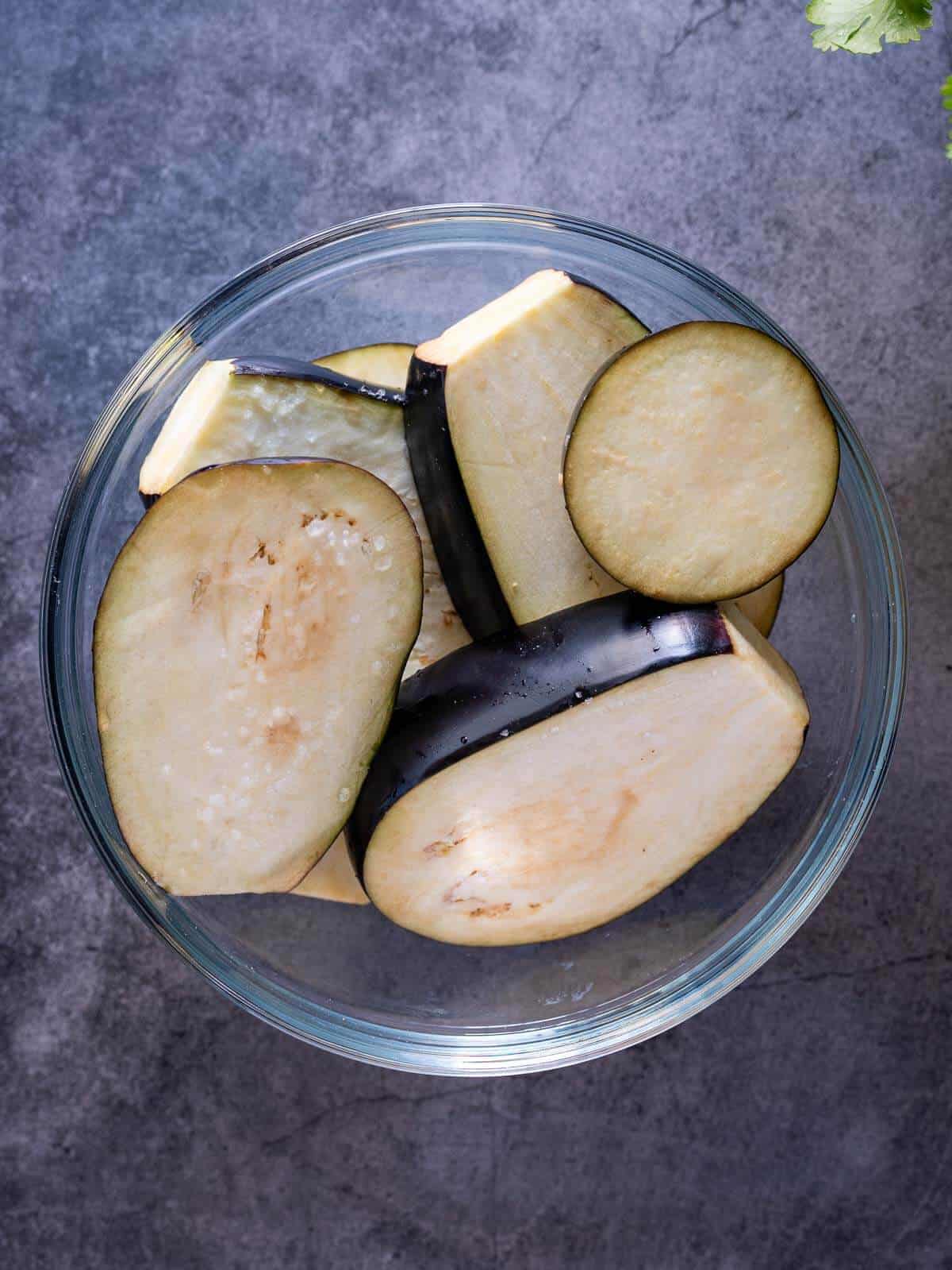 optionally add some coarse salt to make the eggplants less bitter.