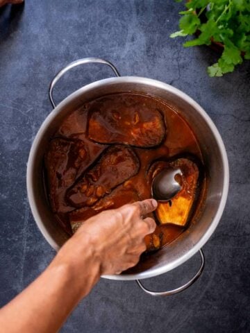 turn the eggplants and smash them with the back of a spoon.