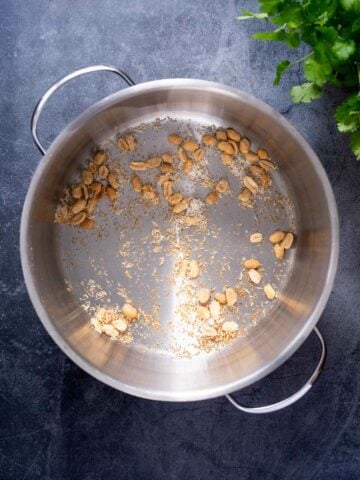 stir fry the shredded coconut and peanuts using coconut oil.