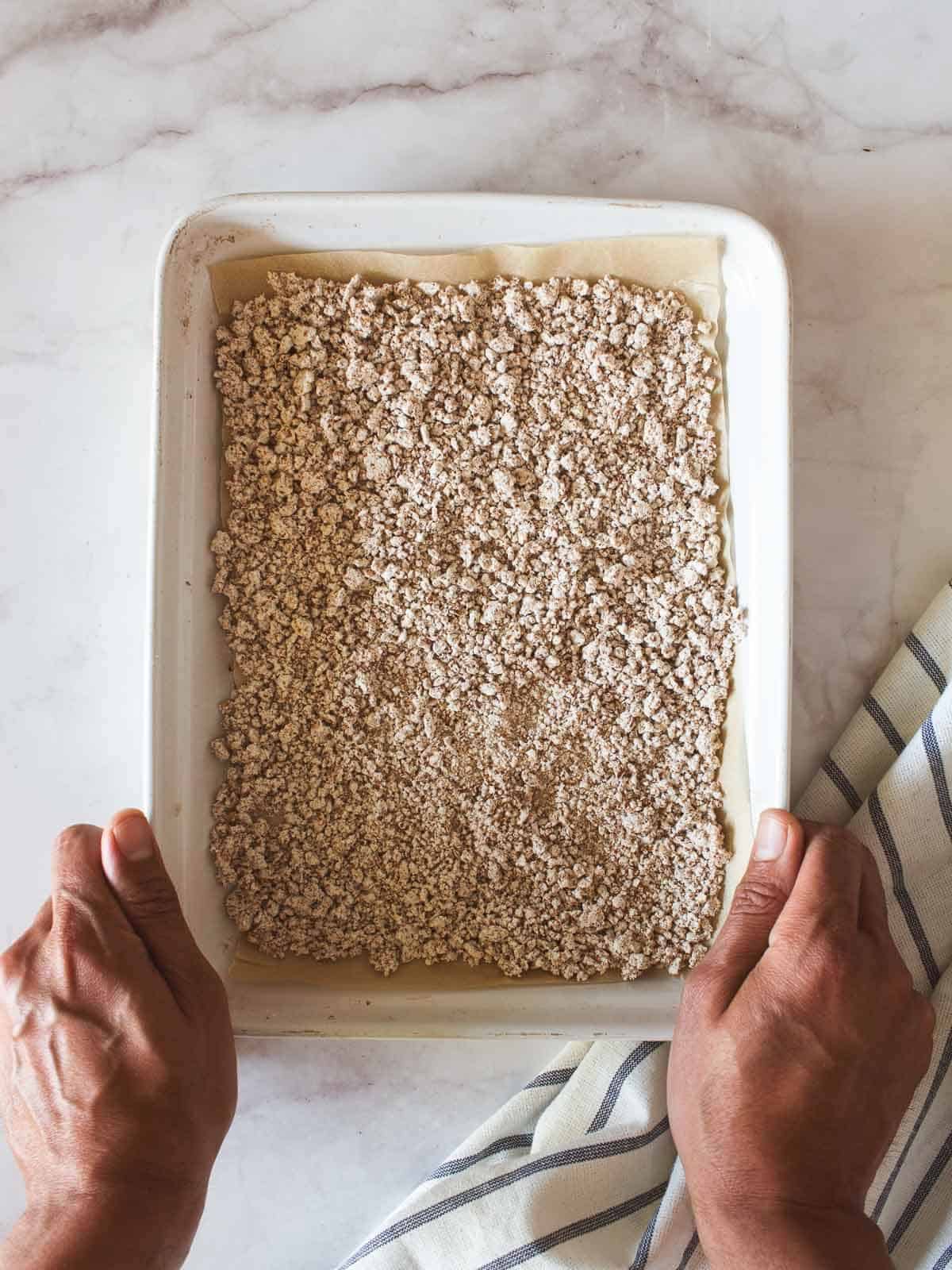 almond pulp in a lines baking sheet with parchment paper