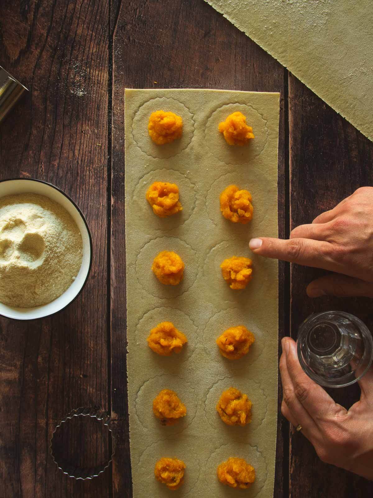 moist the ravioli circles edges with water