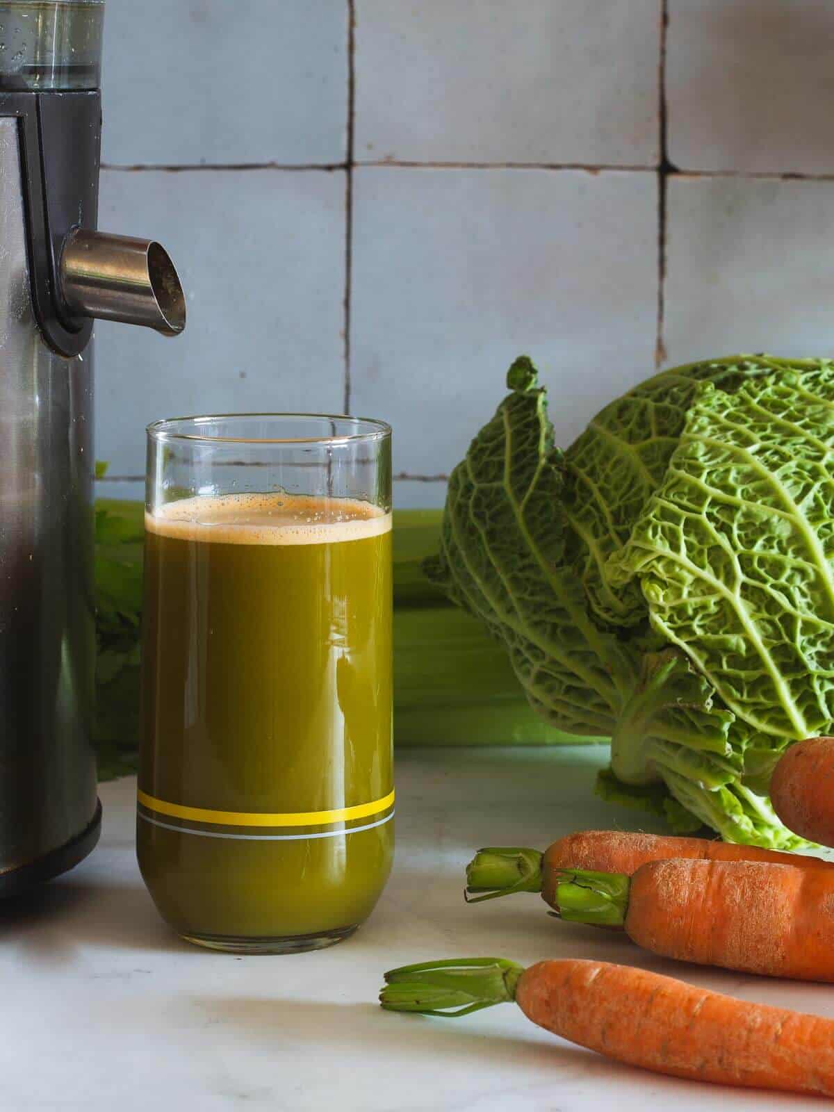 juicing carrots, cabbage, and celery.