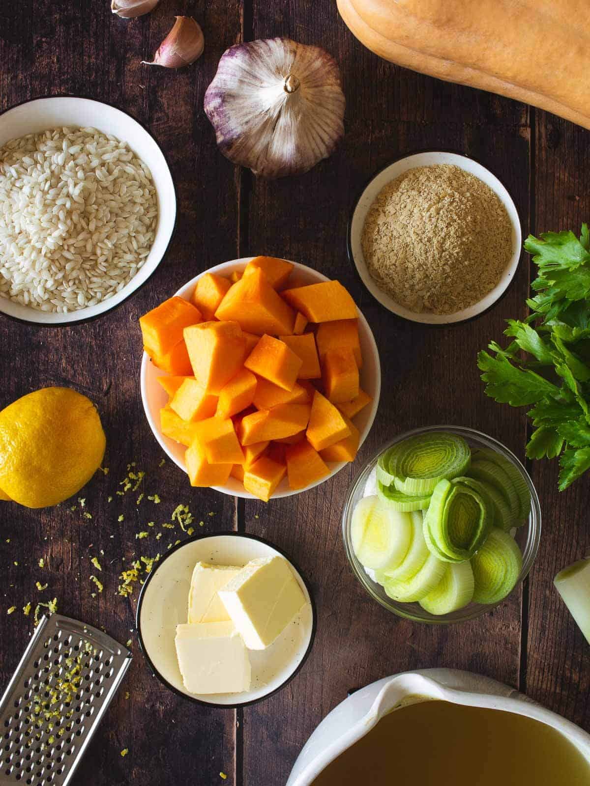 butternut squash risotto ingredients on a wooden table.