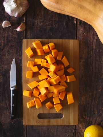 cubed butternut squash in a chopping board.