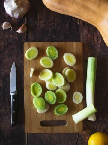 sliced leeks on a chopping board.