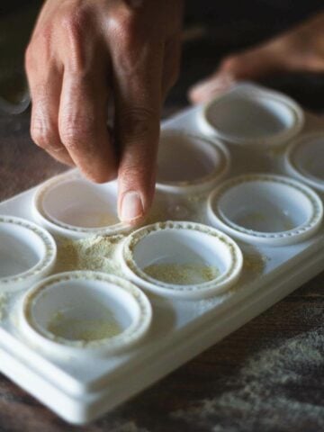 add flour in every pocket of teh tray to prevent sticking.