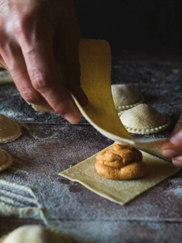 cut vegan pasta rectangles, top with filling, moist edges place a second pasta layer