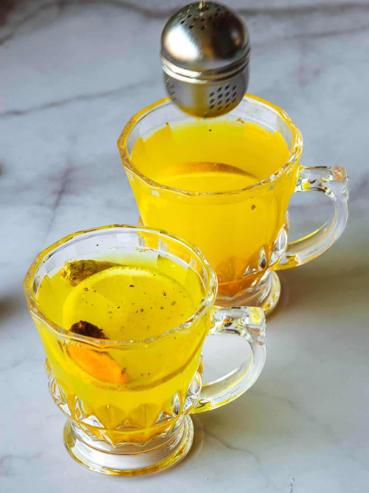 tea cups serves with lemon ginger turmeric tea.