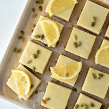 oil free lemon bars decorated with half sliced lemons and pumpkin seeds