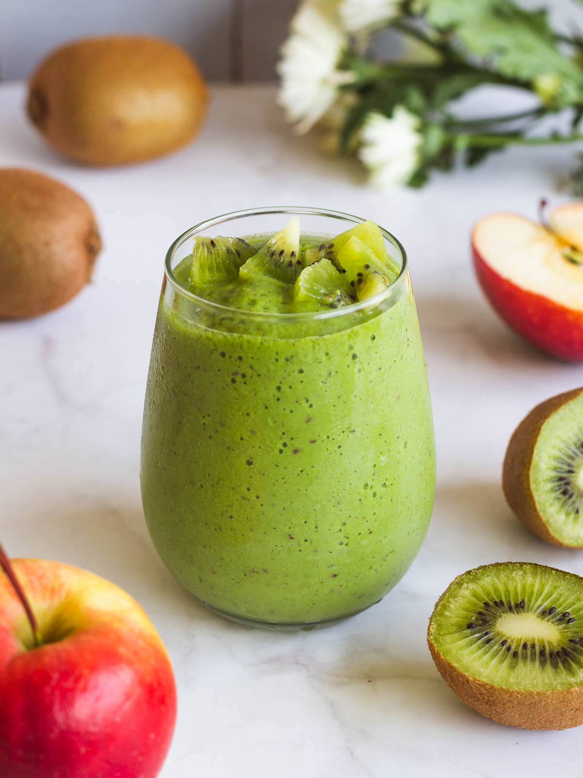 spinach apple smoothie glass with fruit