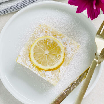 gluten-free and dairy free lemon bars on a plate with a fork