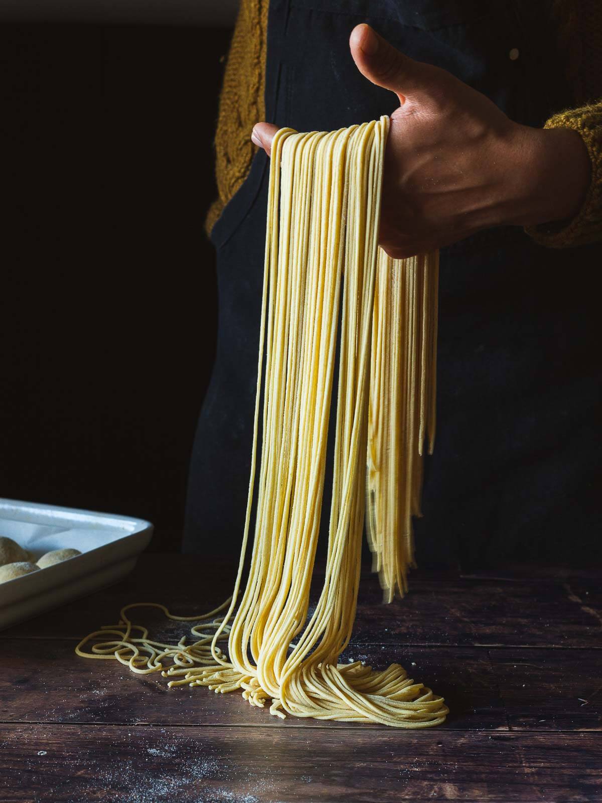 holding pasta noodles with a hand