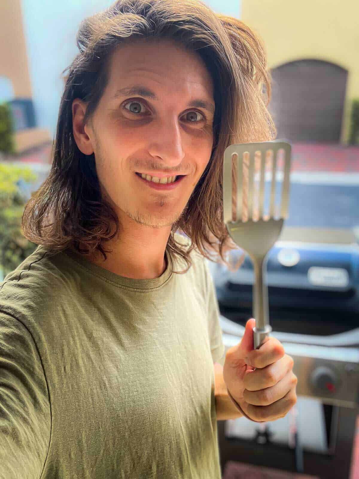 cook holding a spatula