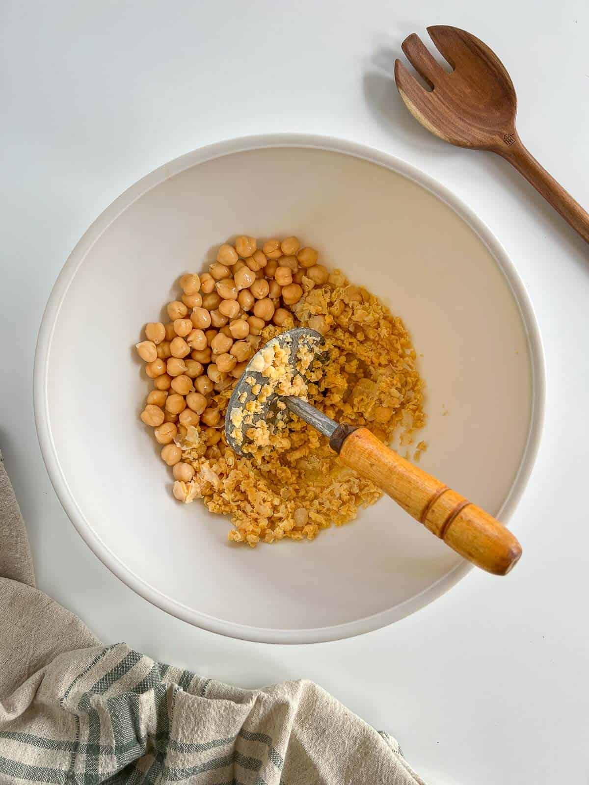 mash the cooked chickpeas with a potato masher