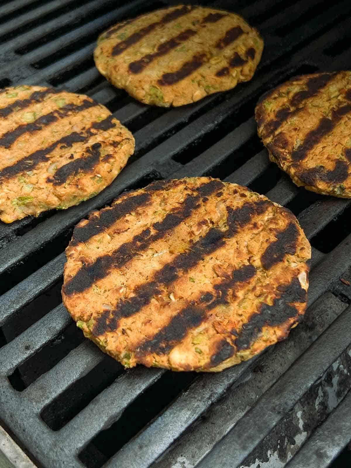 upside down chickpea burgers after turning them, with grill marks