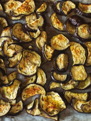 sliced roasted eggplant slices on parchment paper.