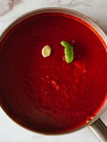 tomato sauce with garlic and basil in a saucepan.
