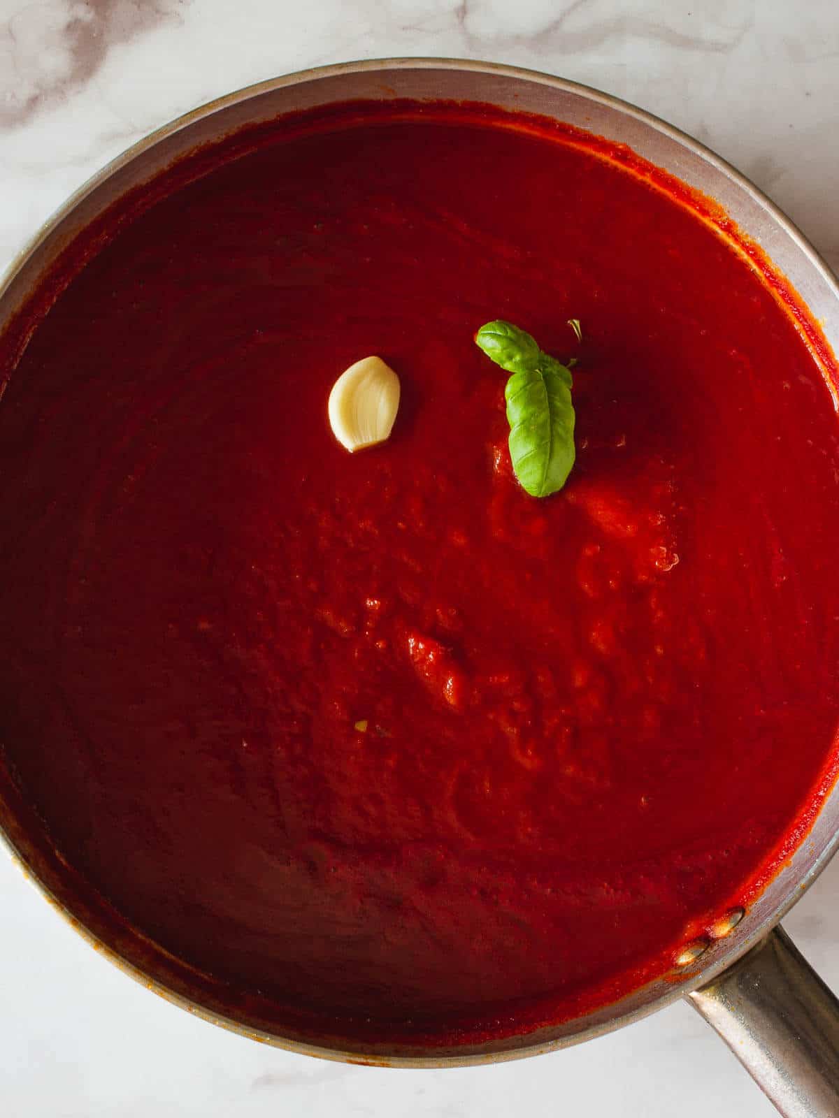 tomato sauce with garlic and basil in a saucepan.