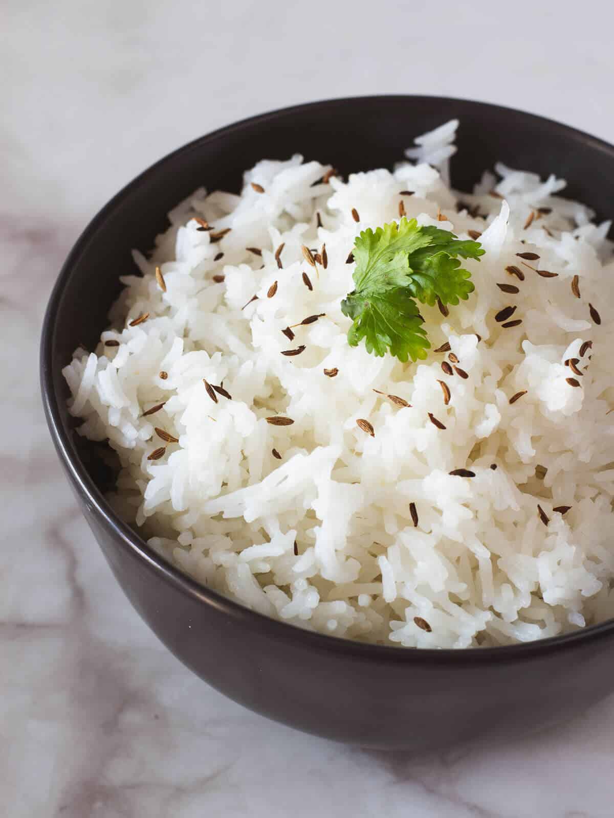 fluffy rice with toasted cumin seeds and coriander leave on top