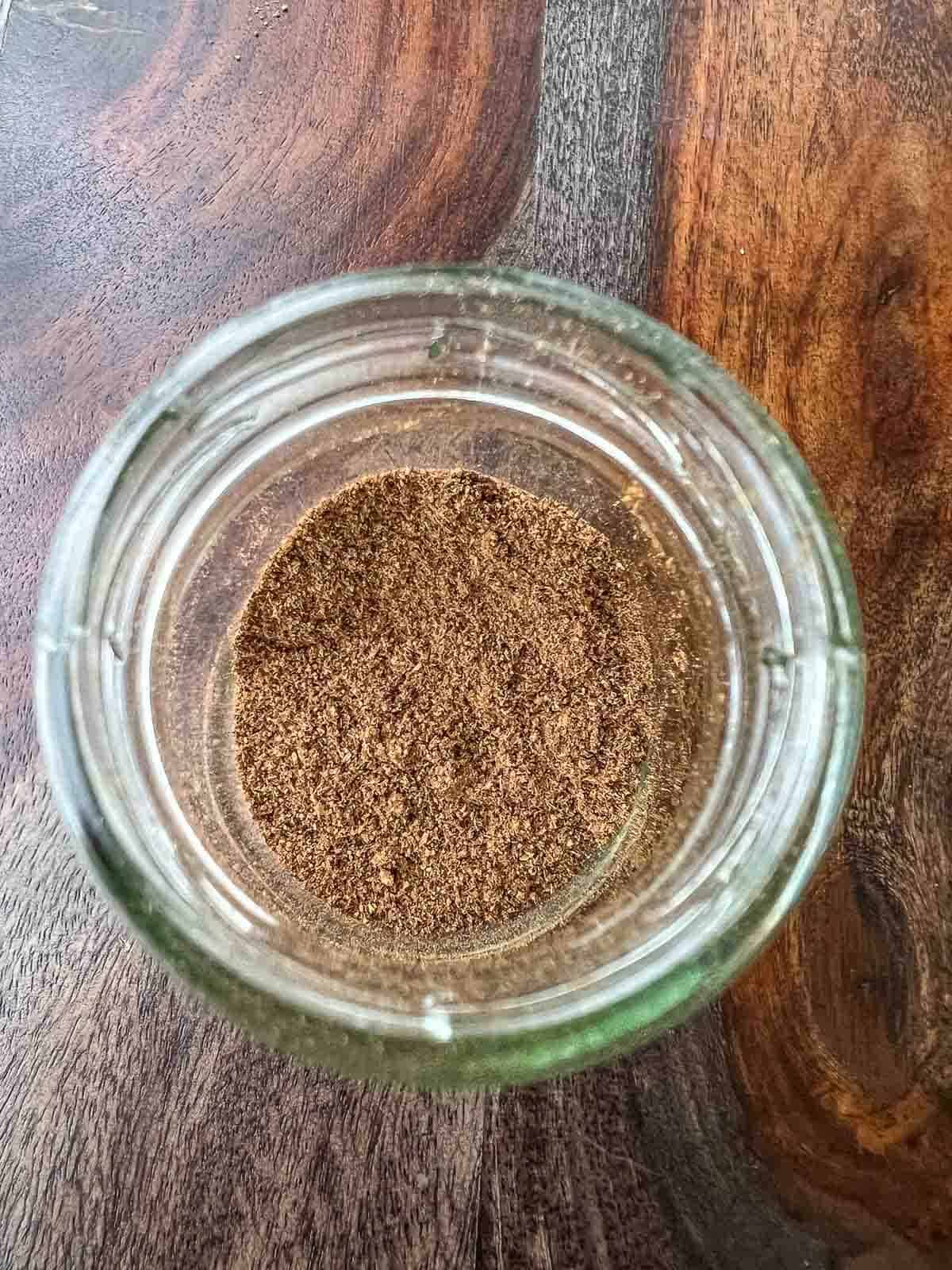 mixing Lebanese seven spices in a mason jar.