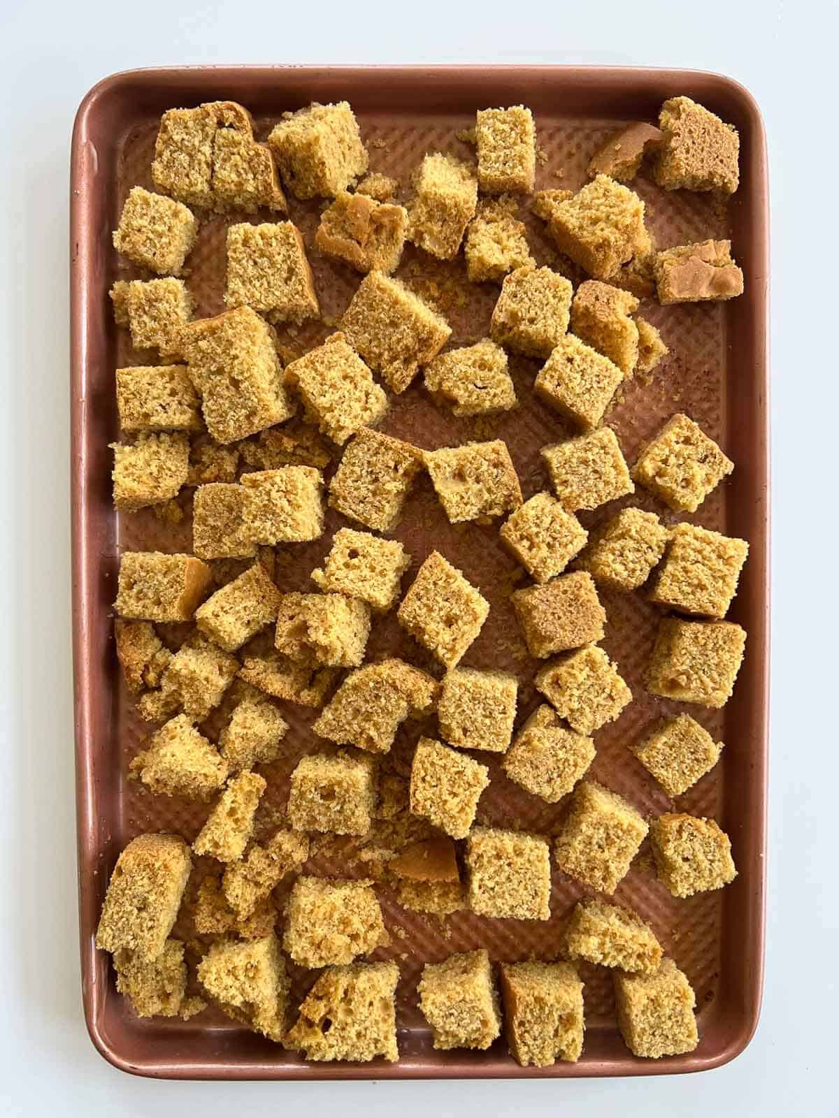 cornbread cubes in baking sheet.