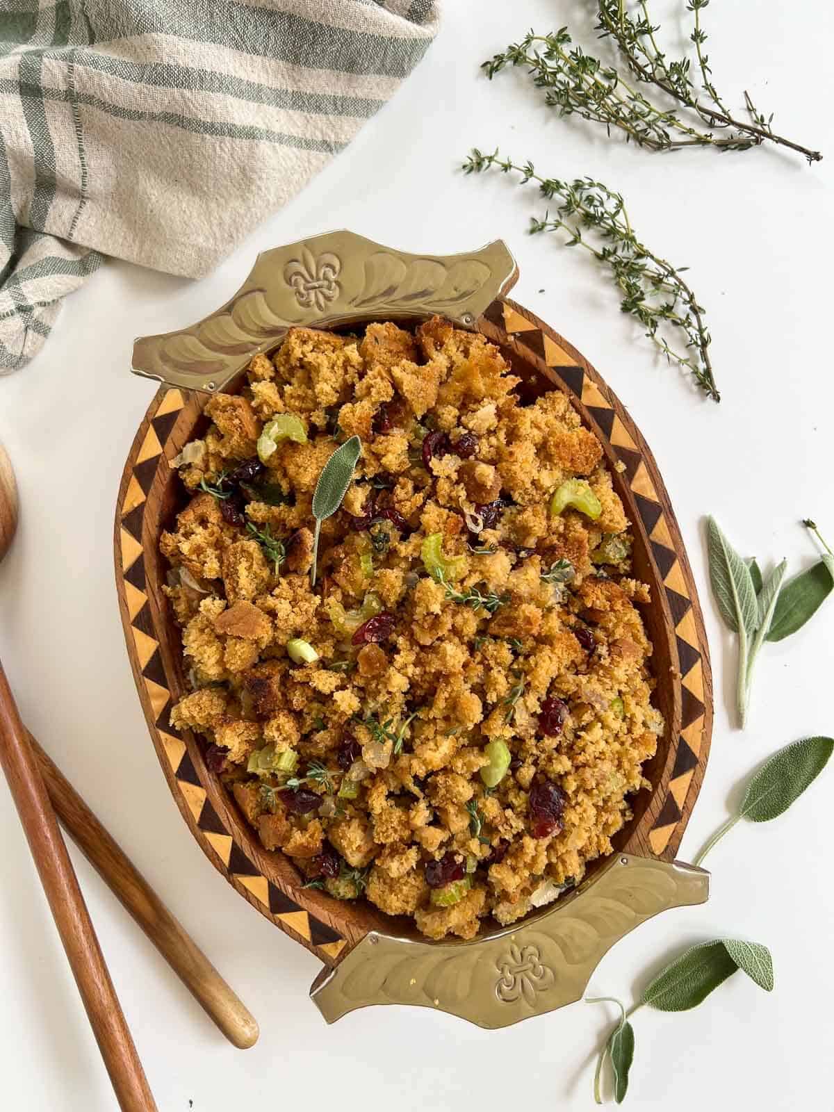 cornbread stuffing served in the table with fresh herbs.