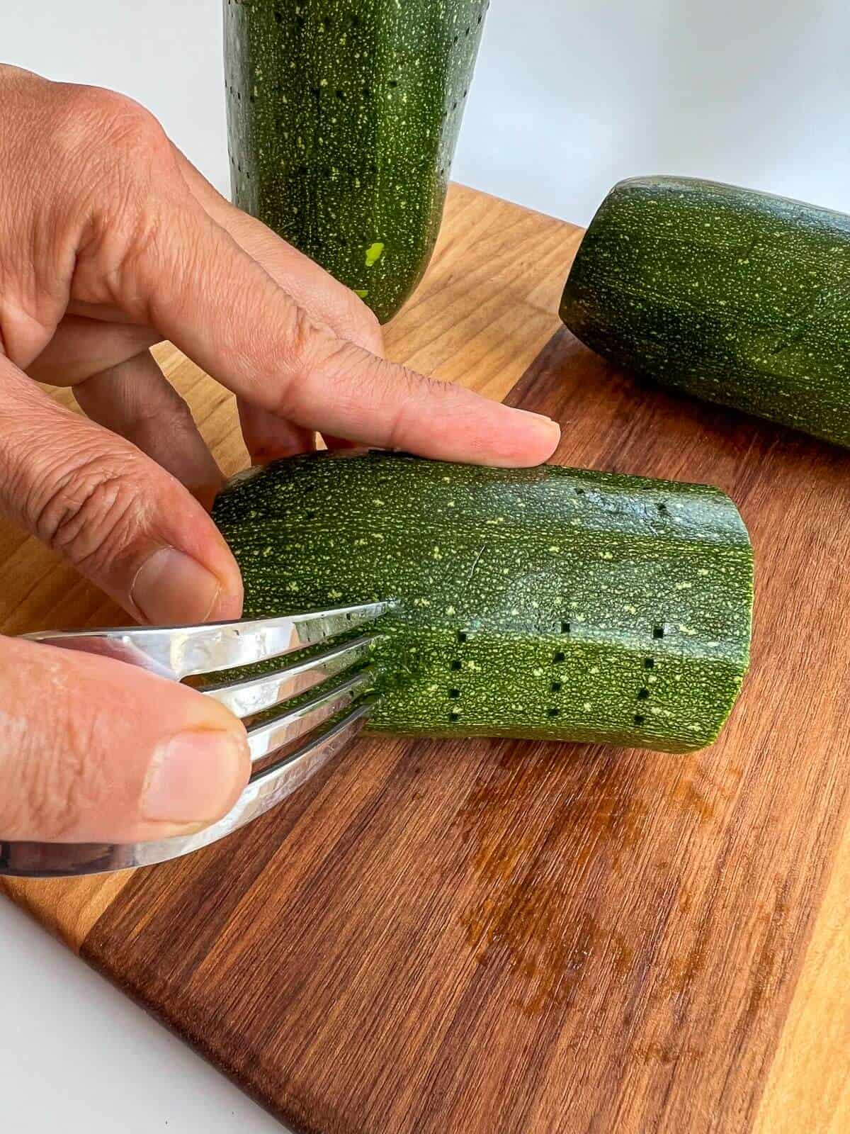 piercing zucchini outer side with a fork.