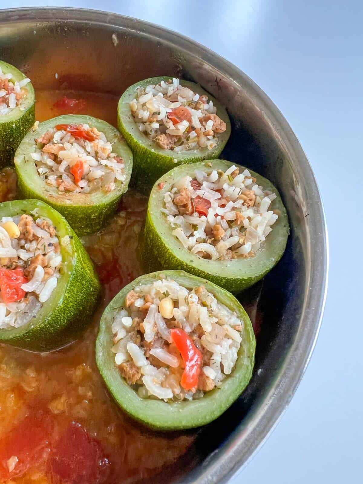 cooked stuffed zucchini in saucepan.