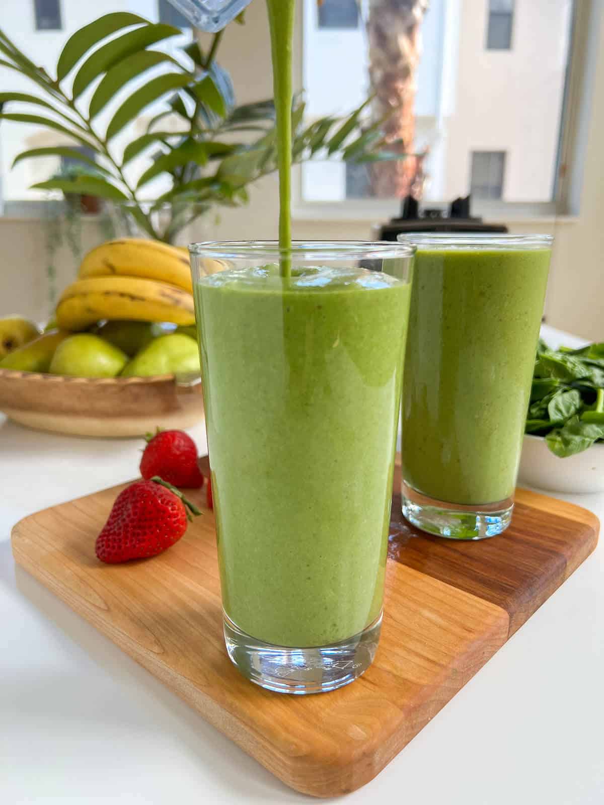 serving spinach smoothie in a glass.