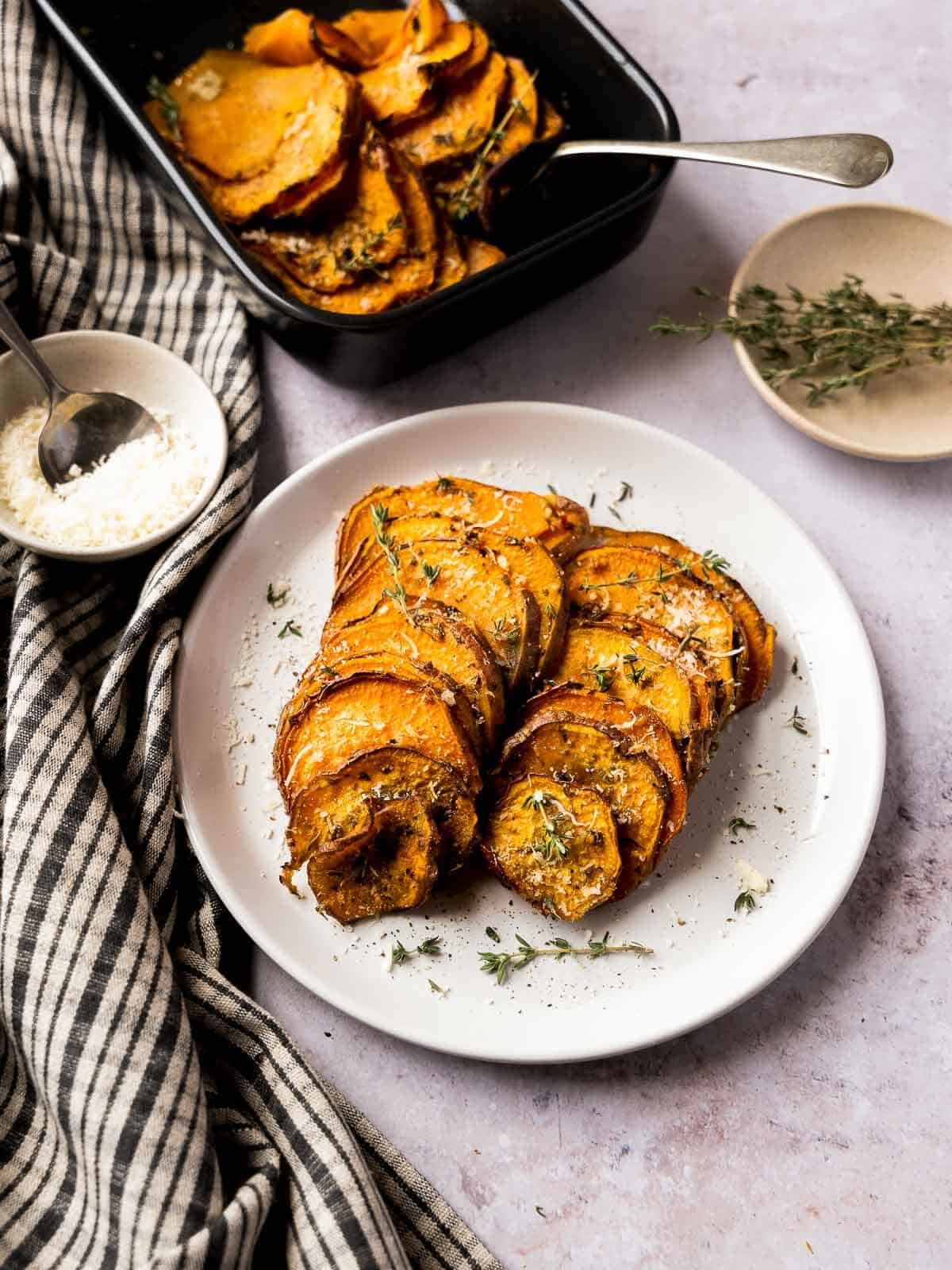 oven baked sweet potato slices served next to baking dish.