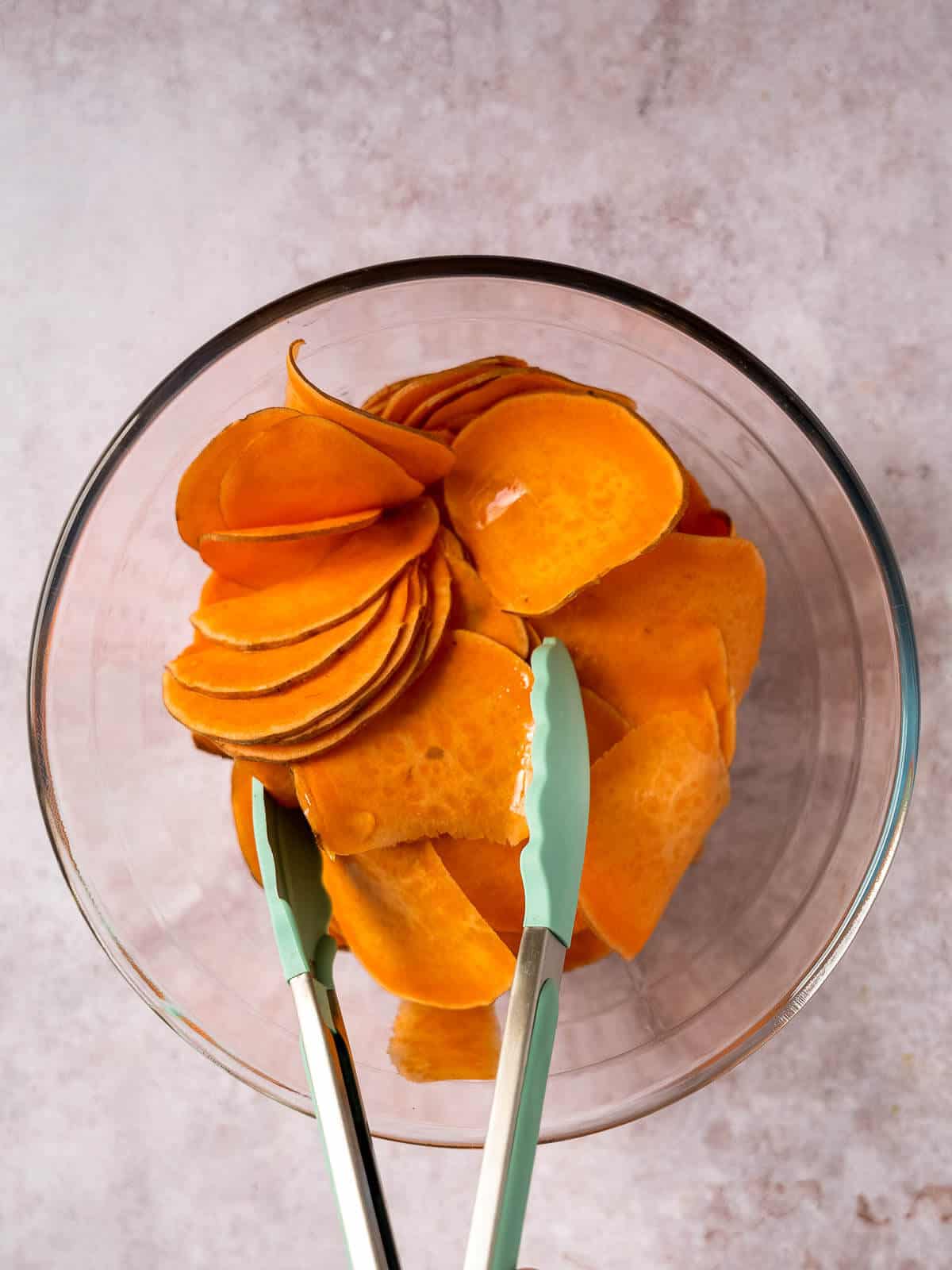 mix seasoning to evenly coat the sweet potato slices.