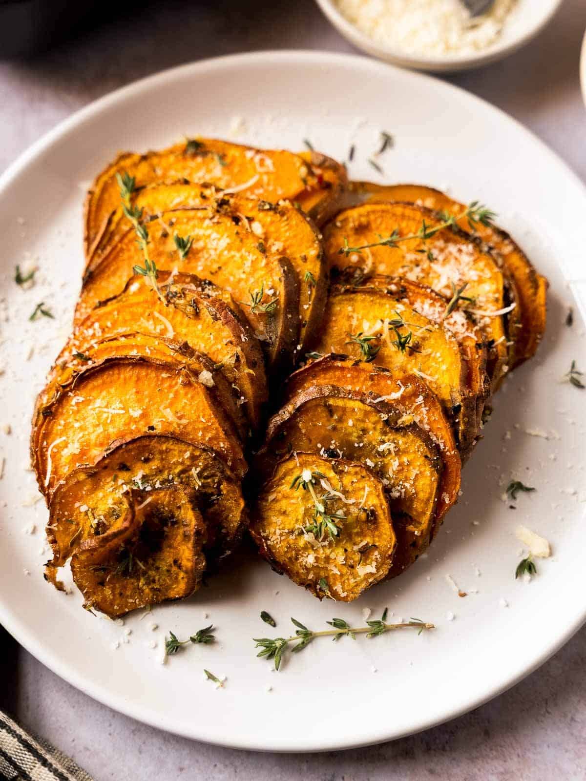 oven baked sweet potato slices served in white plate.