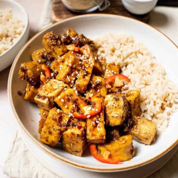 Sichuan style sticky tofu served in white bowl with steamed rice.